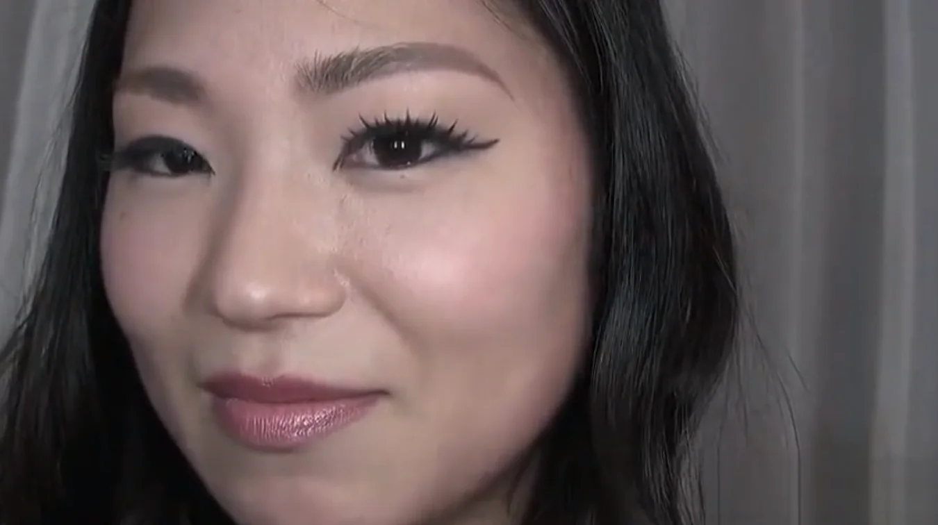 mature woman in white dress sits on young man